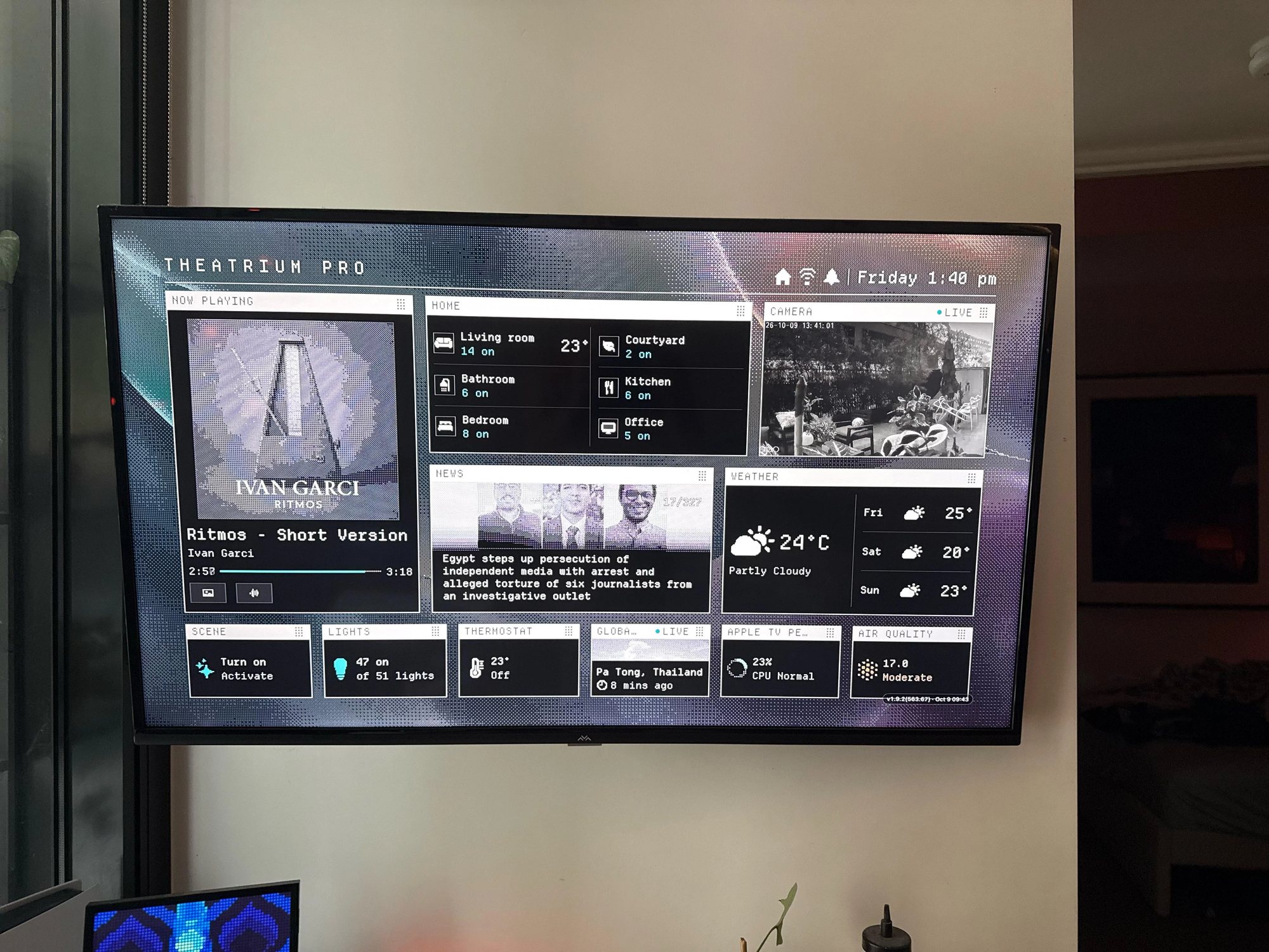Classic running on a wall-mounted television: Now Playing with dithered album art, Home rooms, a live camera, News, Weather and a strip of small cards along the bottom.