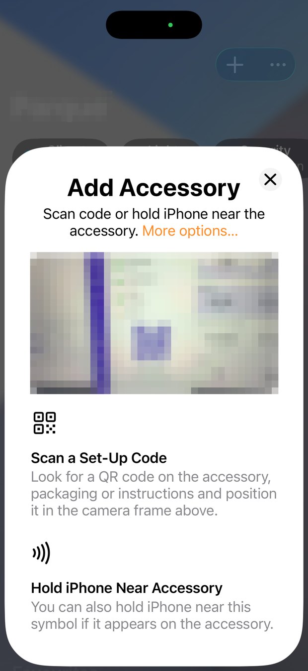 The iPhone Add Accessory sheet, with the camera pointed at the Homebridge screen.